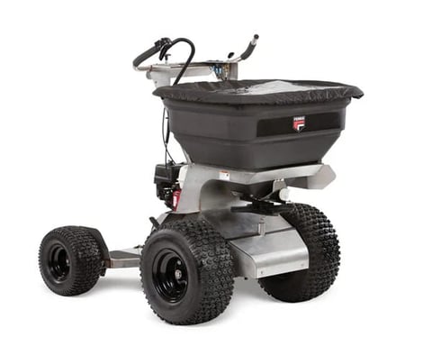 Wheeled broadcast spreader with black hopper and gray frame on four all-terrain tires