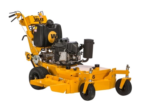 Yellow and black Welke commercial lawn mower with engine mounted on top and wide cutting deck