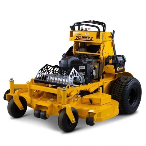 Yellow stand-on zero-turn mower with black accents and large rear tires on white background